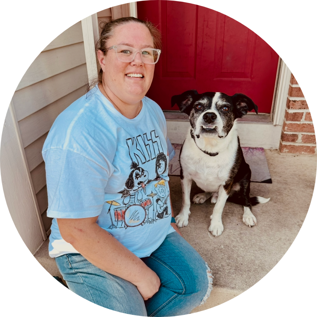 Smiling woman with black-and-white dog